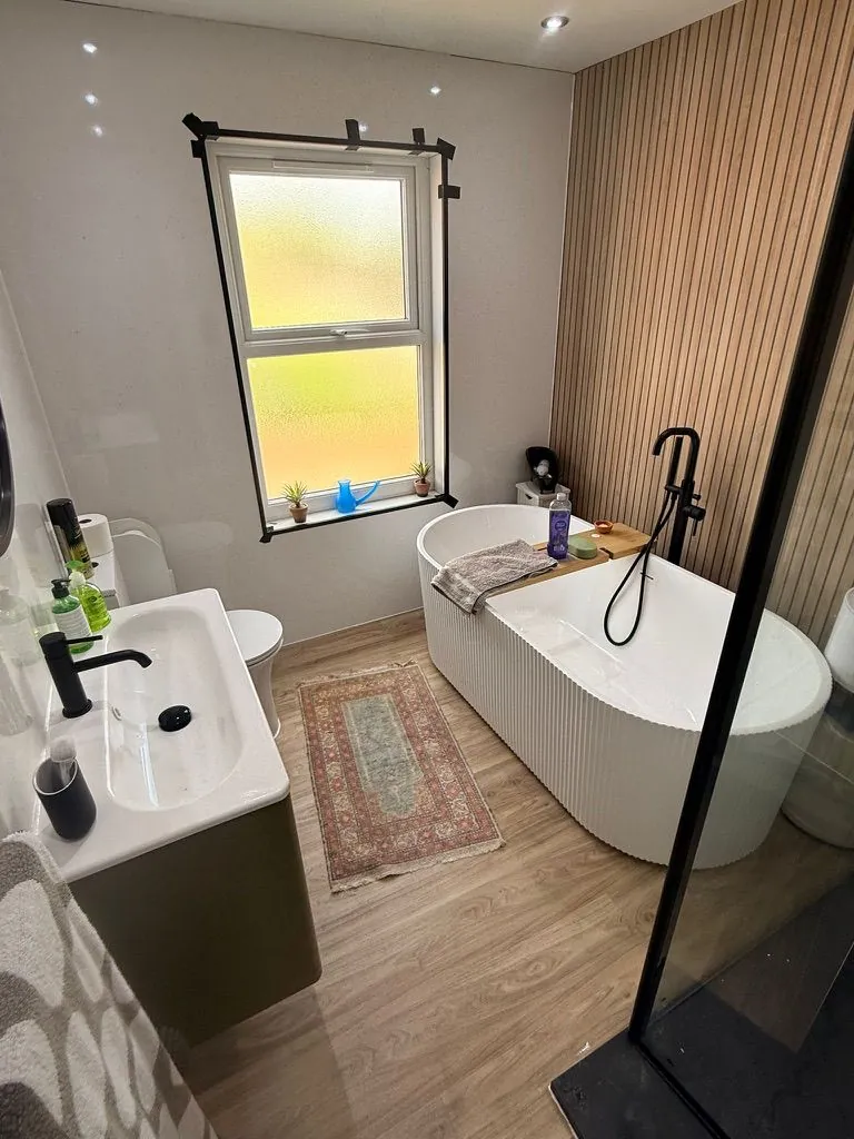 Bathroom installation in Crewe with freestanding bath and walk-in shower by Warm-Wise